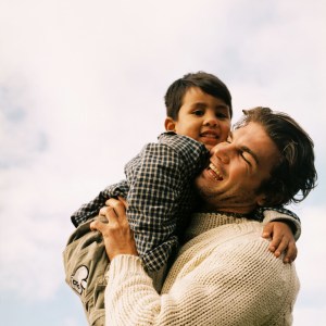 Young Father Holding His Young Son (4-6)